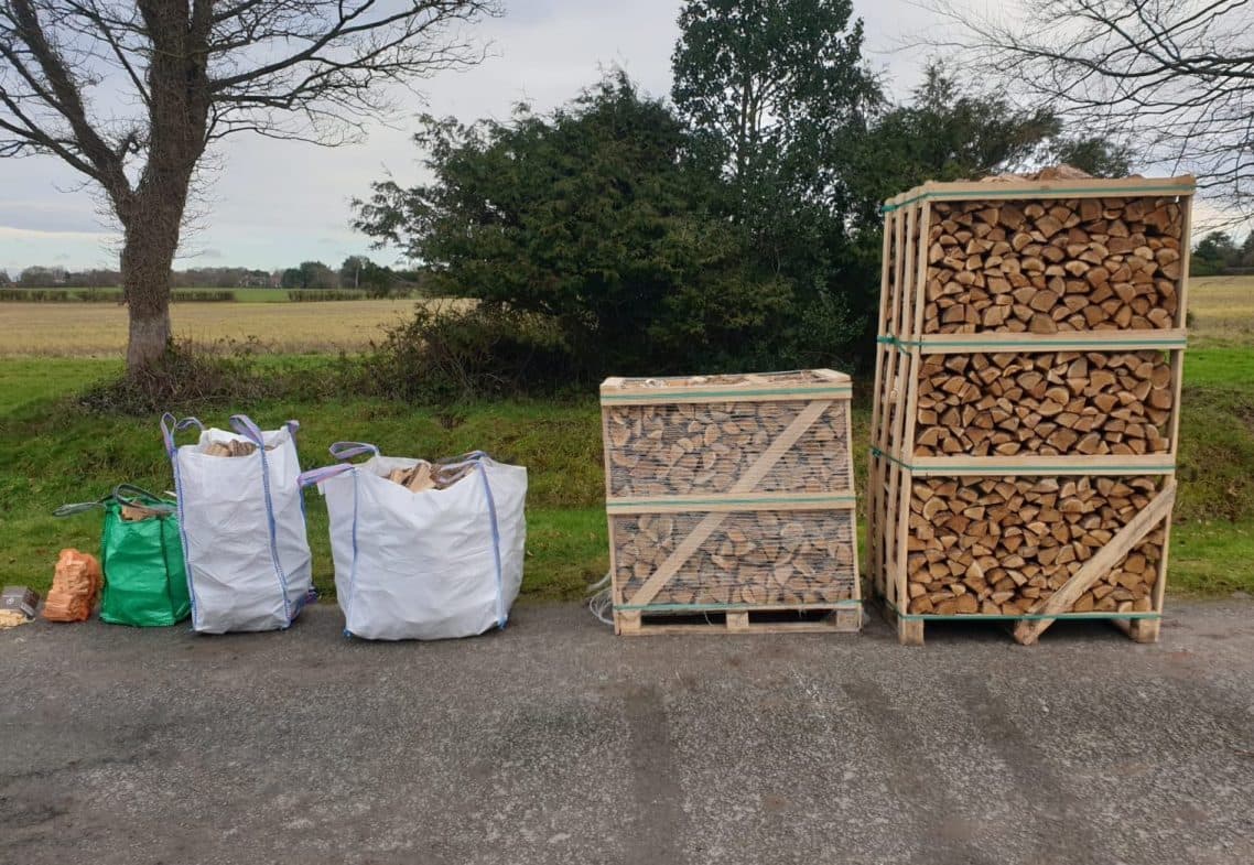 Bags and pallets of Northwest Firewood Company's kiln-dried logs lined up ready for delivery